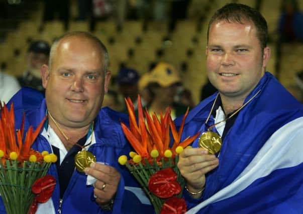 Alex Marshall, left, and Paul Foster with their gold medals from the mens pairs at Melbourne in 2006. Picture: AP