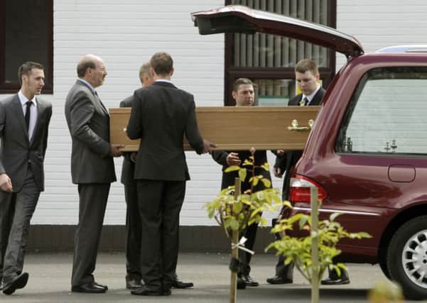 Funeral director employees carry the coffin of Elizabeth Allan, known as Betty, who died during the Jim Clark Rally. Picture: PA
