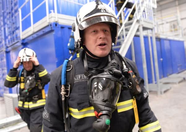 Boris Johnson who experienced a real 'firehouse' has now offered to test riot equipment on himself, to show they are safe. Picture: PA