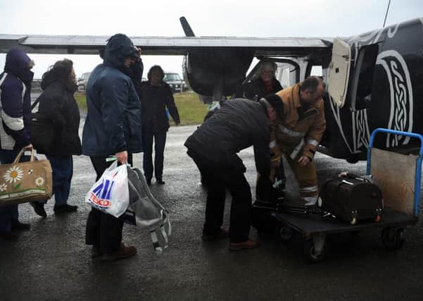 Passangers get on the world's shortest schedule flight at Papa Westray. Picture: TSPL