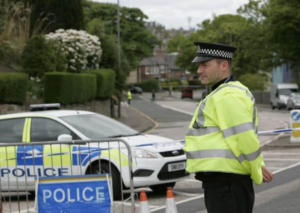 A policeman guards Edinburgh's Willowbrae Road, the site where Mohammed Abdi was fatally shot. Picture: Toby Williams