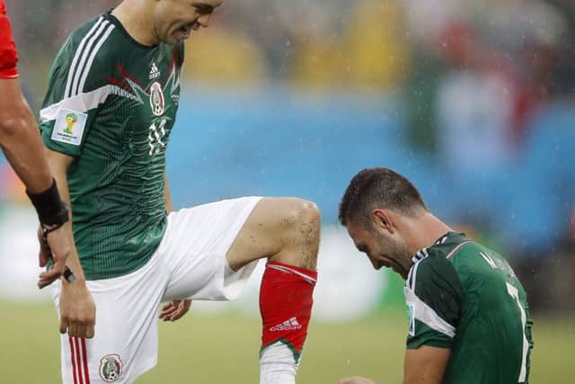 Mexico defender Miguel Layun takes a shine to Oribe Peraltas boots. Picture: AP