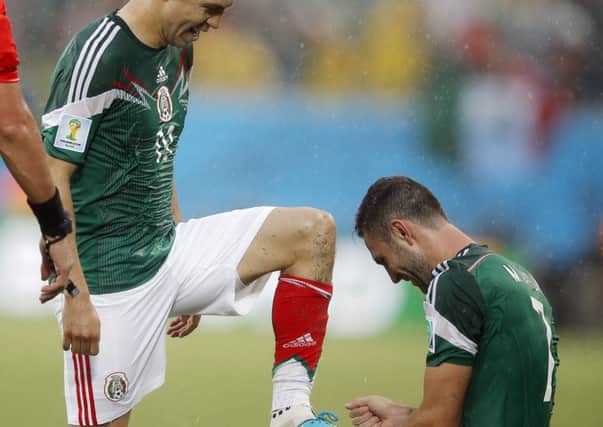 Mexico defender Miguel Layun takes a shine to Oribe Peraltas boots. Picture: AP