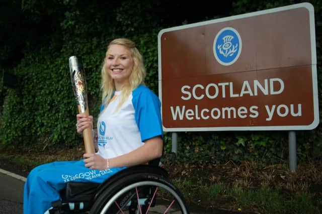 Samantha Kinghorn carrying the Glasgow 2014 Queen's Baton through Coldstream in the Scottish Borders. Picture: PA