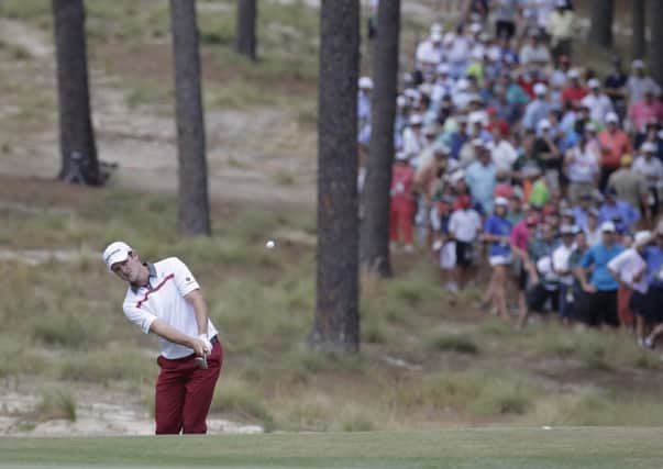 Justin Rose chips to the fifth green during the second round. Picture: AP