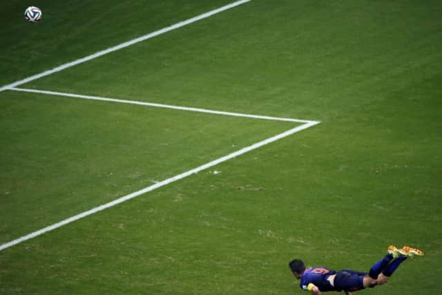 Robin van Persie scores a stunning opener with a diving, looping header. Picture: Getty