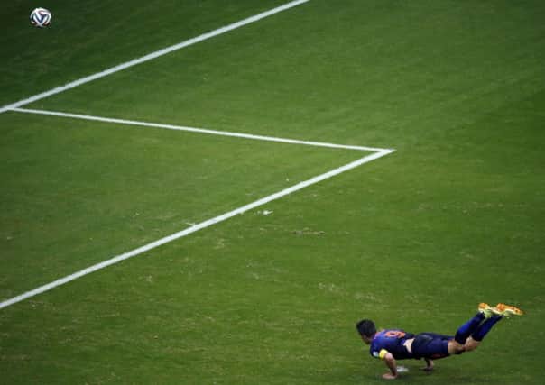 Robin van Persie scores a stunning opener with a diving, looping header. Picture: Getty