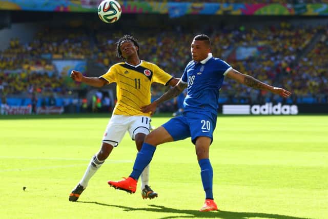 Juan Guillermo Cuadrado of Colombia and Jose Cholevas of Greece fight for the ball. Picture: Getty