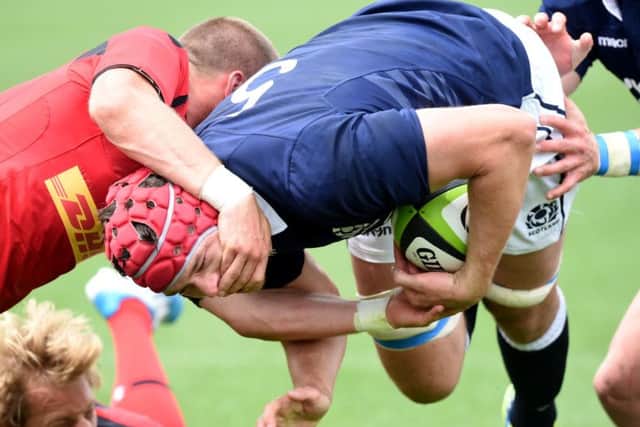 Scotlands Grant Gilchrist powers through the Canadian defence to score. Picture: SNS