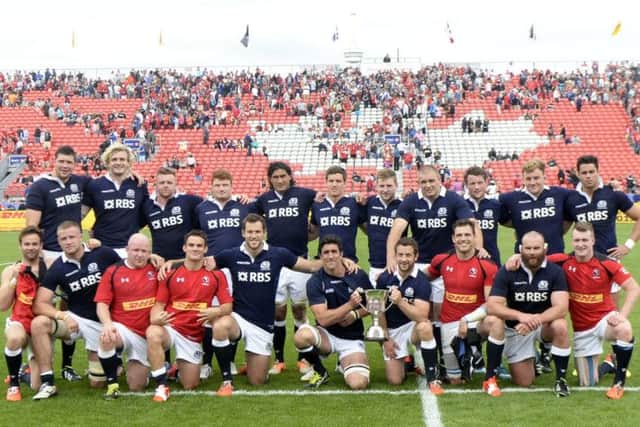 Scotland celebrate with the Douglas JL Horn Memorial Cup after victory over Canada. Picture:  SNS