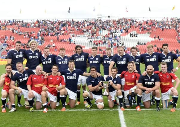 Scotland celebrate with the Douglas JL Horn Memorial Cup after victory over Canada. Picture:  SNS