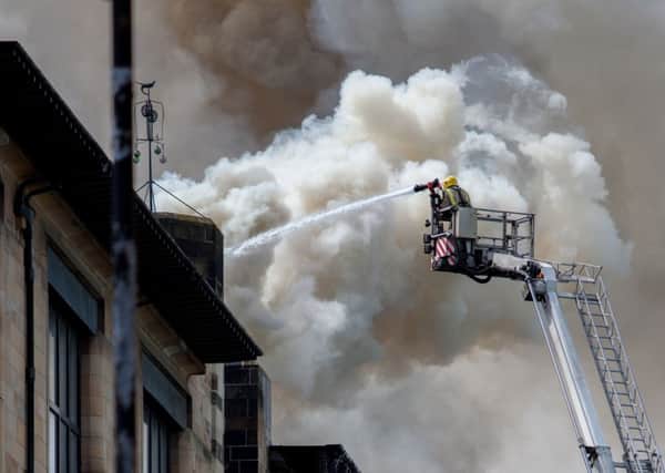 Firefighters tackle the Macintosh building blaze. Picture: Getty