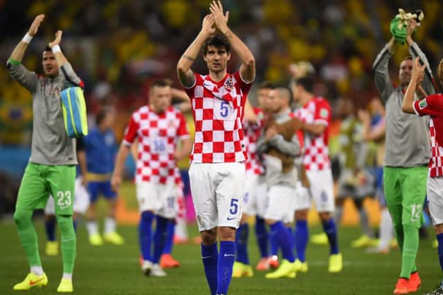 The Croatian team (fully clothed) applaud their fans after the match with Brazil. Picture: Getty