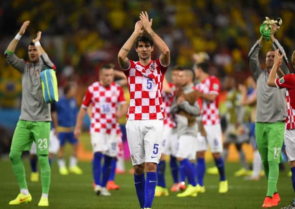 The Croatian team (fully clothed) applaud their fans after the match with Brazil. Picture: Getty