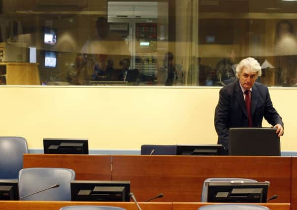 Mass murderers such as Radovan Karadzic have occupied the glass box at The Hagues international criminal court. Picture: AFP