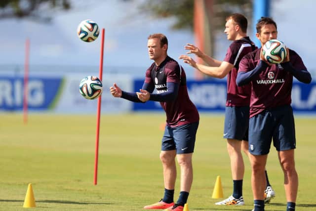 Wayne Rooney, left, trains in Rio de Janeiro with the England squad yesterday. Picture: PA
