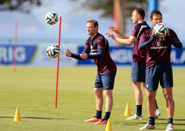 Wayne Rooney, left, trains in Rio de Janeiro with the England squad yesterday. Picture: PA