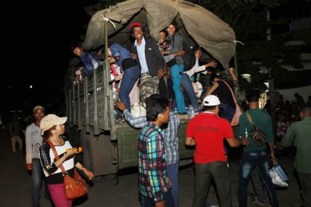 Cambodian migrant workers sit on a military truck as they return to their homeland from Thailand. Picture: AP