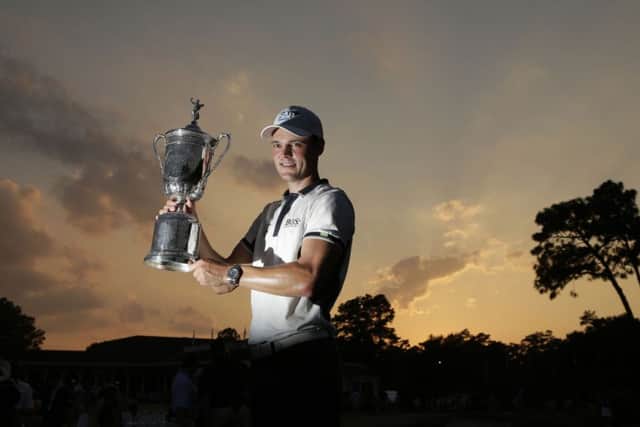 Martin Kaymer holds the US Open trophy aloft after his massive victory on Sunday. Picture: AP