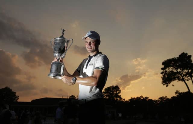 Martin Kaymer holds the US Open trophy aloft after his massive victory on Sunday. Picture: AP