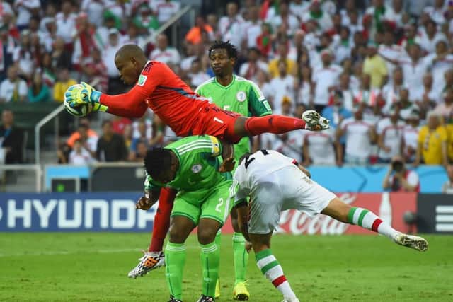 Nigeria's Vincent Enyeama makes a save over Joseph Yobo and Ashkan Dejagah. Picture: Getty