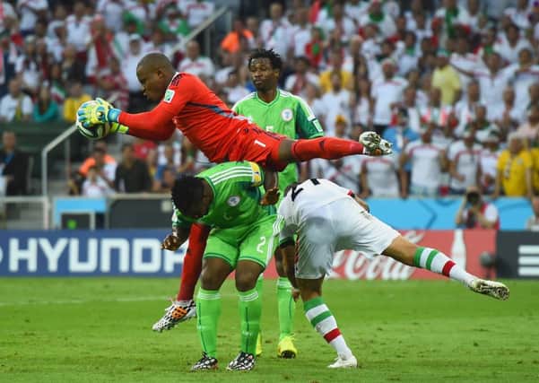 Nigeria's Vincent Enyeama makes a save over Joseph Yobo and Ashkan Dejagah. Picture: Getty