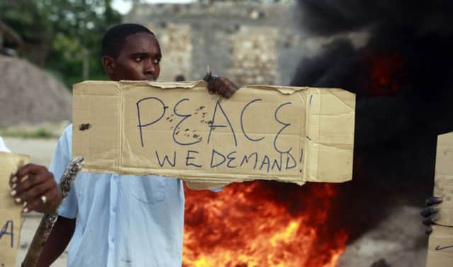 A resident joins a peace demonstration in the coastal town of Mpeketoni. Picture: Reuters