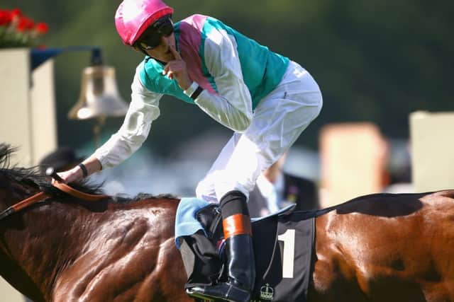 Jockey James Doyle makes his silence gesture after riding Kingman to victory at Ascot. Picture: Getty