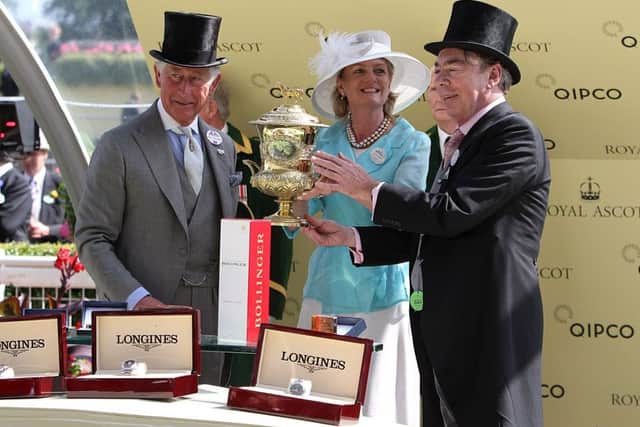 Lord and Lady Lloyd Webber receive the Prince of Waless Stakes trophy from Prince Charles yesterday. Picture: PA