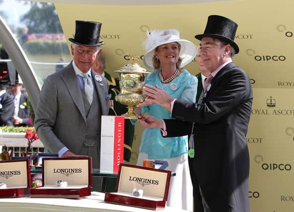 Lord and Lady Lloyd Webber receive the Prince of Waless Stakes trophy from Prince Charles yesterday. Picture: PA