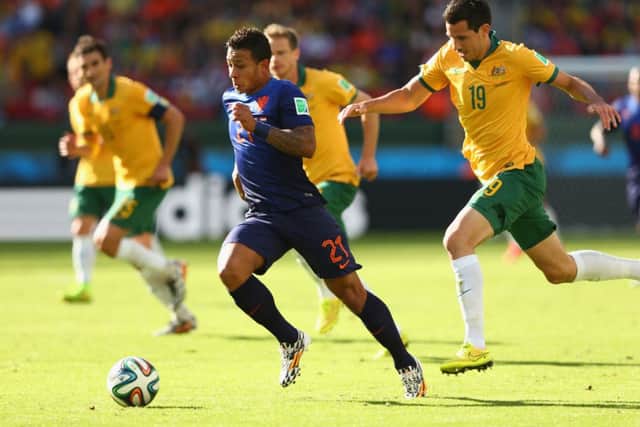 Memphis Depay is chased by former Hearts player Ryan McGowan. Picture: Getty