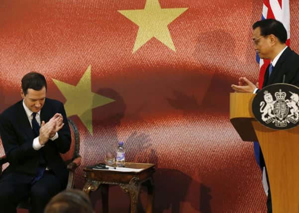 Li Keqiang, right, and Chancellor George Osborne applaud at the end of the Chinese Premier's speech in London. Picture: Getty