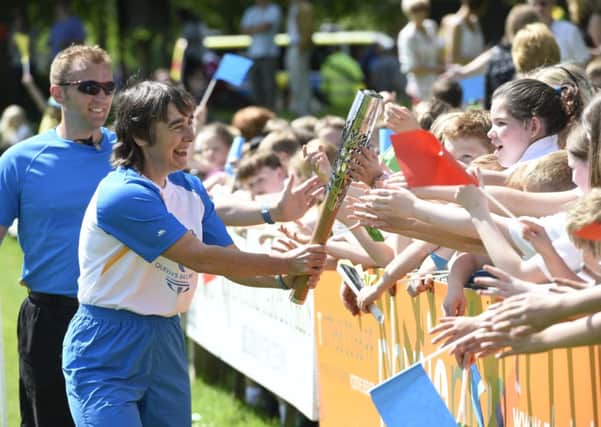 Batonbearer Jane Sargent carries the Glasgow 2014 Queen's Baton through Melrose. Picture: Getty