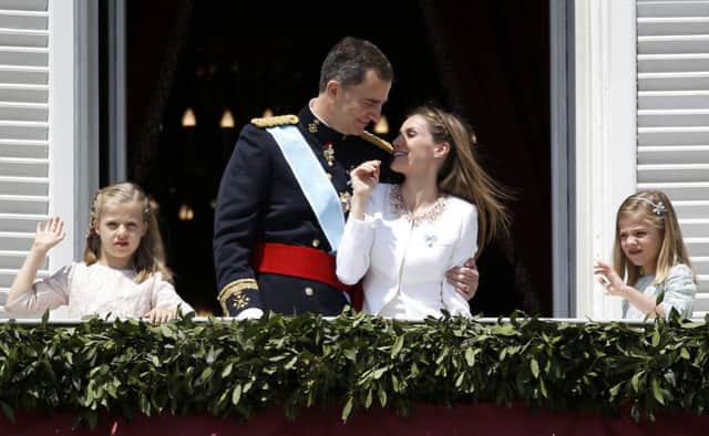 King Felipe VI and Queen Letizia appear on the balcony of the Royal Palace in Madrid yesterday. Picture: Reuters