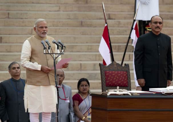 Indias prime minister Narendra Modi takes the oath of office. He began reforms immediately. Picture: AP