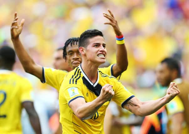 James Rodriguez of Colombia celebrates after scoring his team's first goal against the Ivory Coast. Picture: Getty