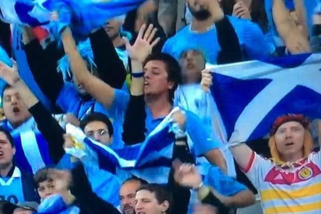 The Scotland fan celebrates with jubilant Uruguay fans in the Corinthians Arena. Picture: Contributed