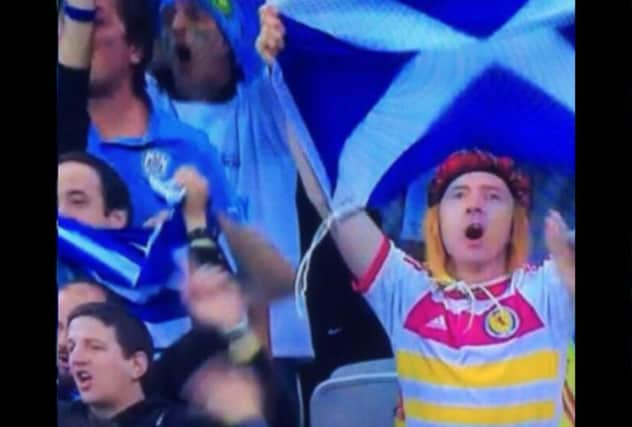 The Scotland fan celebrates with Uruguayan supporters at the Corinthians Arena. Picture: Contributed