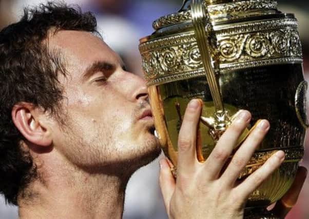 Andy Murray kisses the trophy after defeating Novak Djokovic in last years Wimbledon final.  Picture: AP