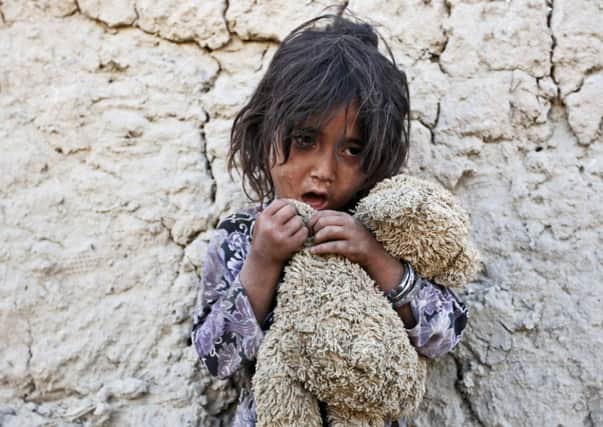 Fatima 7, poses for a photograph at a camp for internally displaced Afghans on World Refugee Day in Kabul, Afghanistan. Picture: AP