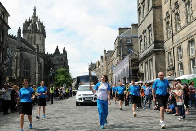 The Commonwealth Games Queens Baton Relay being carried through Edinburgh City Centre. Picture: TSPL