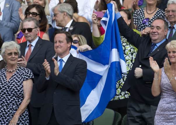 Alex Salmond celebrates with a Saltire after Andy Murray's victory in the Wimbledon final. Picture: SNS