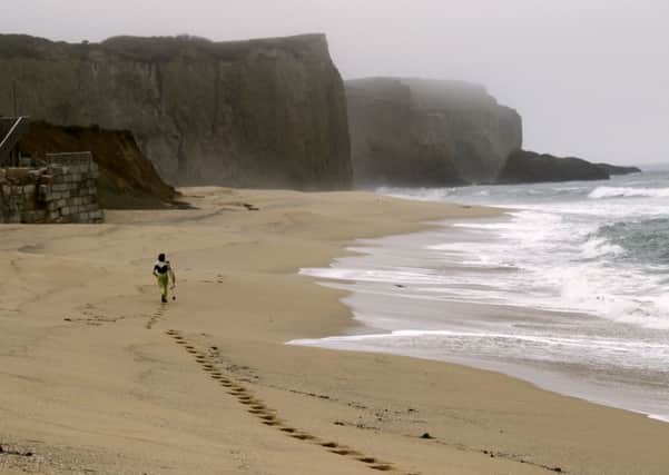 A lone surfer on Martins Beach, California. Picture: Reuters