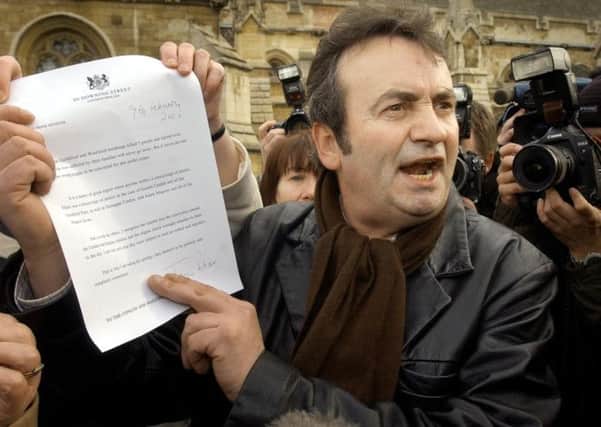 Gerry Conlon outside the House of Commons showing the media the letter of apology he received from Prime Minister Tony Blair. Picture: PA