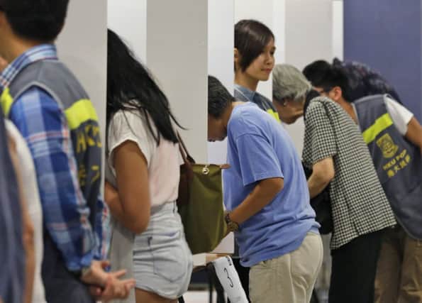 Many in Hong Kong voted electronically in the referendum, but some preferred the traditional polling station. Picture: AP