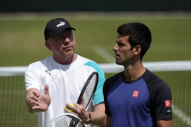 Novak Djokovic listens to his coach Boris Becker during his training session at Wimbledon. Picture: Getty