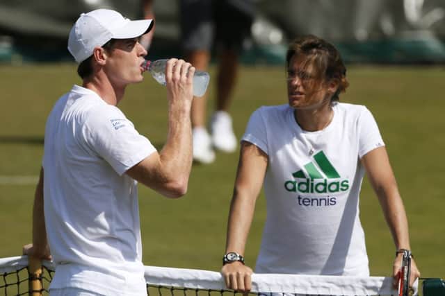 A relaxed Andy Murray takes a break from practice in the company of new coach Amelie Mauresmo. Picture: Reuters