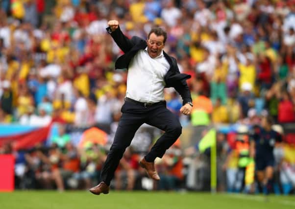 Belgium head coach Marc Wilmots jumps for joy after his side snatched a vital win. Picture: Getty