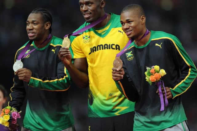 Yohan Blake, left, with Usain Bolt and Warren Weir on the podium at London 2012. Picture: Ian Rutherford
