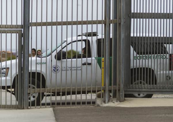 A truck of the US Border Patrol  guards the fence that divides Mexico and the US. Picture: AFP